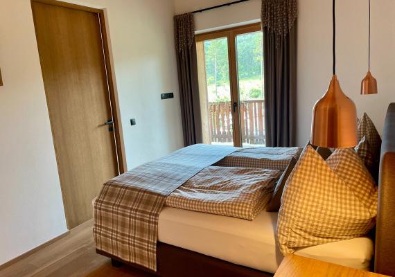 Bedroom with double bed and cozy lighting.