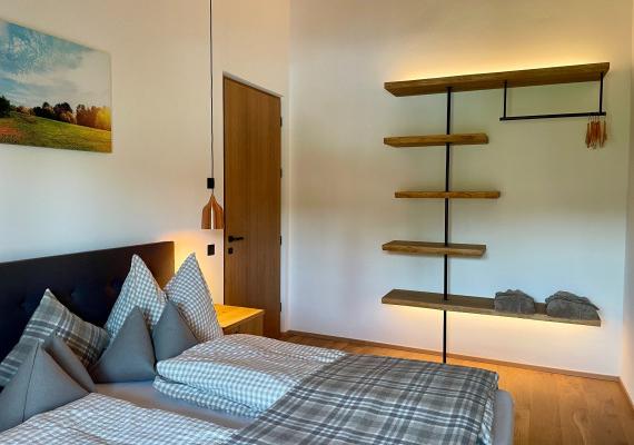 Bedroom with double bed and cozy lighting.