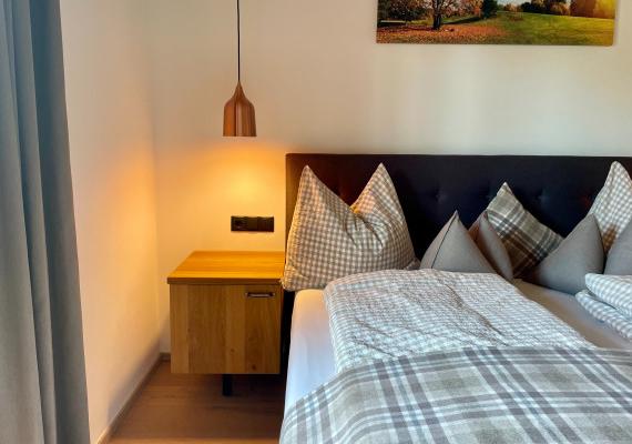 Bedroom with double bed and cozy lighting.